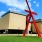 a red sculpture in front of a building