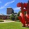 a large red statue in a yard