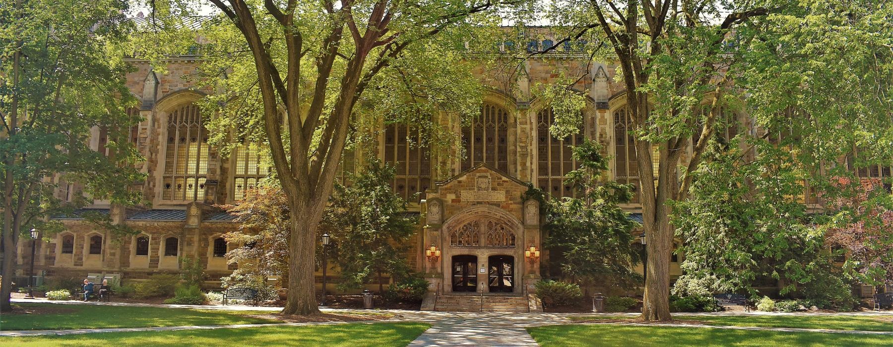 a large building with trees in front of it