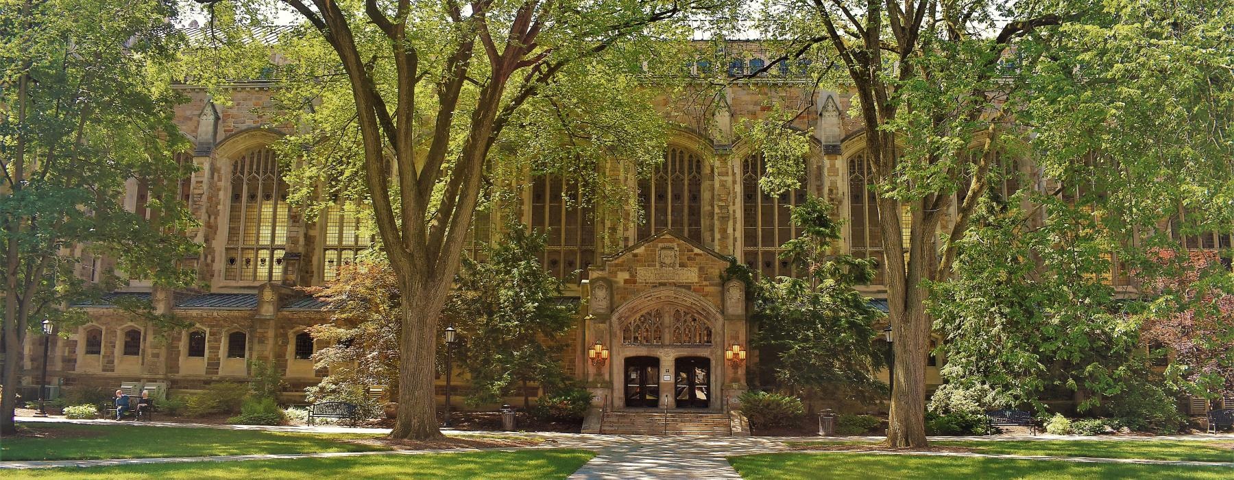 a large building with trees in front of it