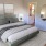a bedroom with a bed and lamps